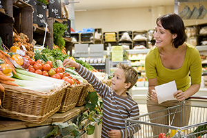 Woman and boy grocery shopping.