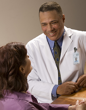 Healthcare provider talking to woman.