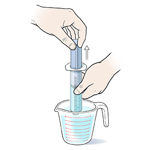 Close-up of hands drawing water into twist-on syringe from measuring cup.