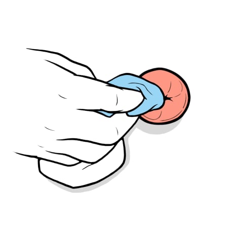 Hand wiping stoma with wet cloth.