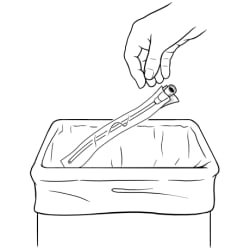Person putting used catheter into trash.