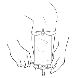 Empty leg catheter bag on leg with hands fastening bottom leg strap.