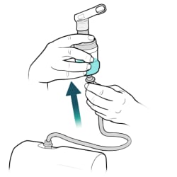 One hand pushing tubing onto port on bottom of medicine cup, with other hand holding cup.