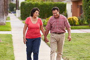 Man and woman outdoors walking.