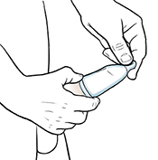 Condom being rolled down onto erect penis.