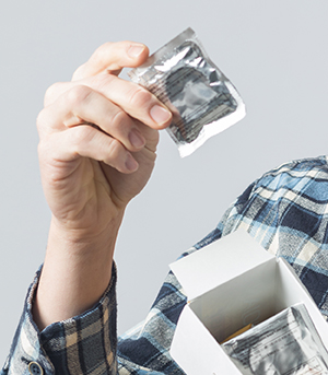 Person holding box of condoms.